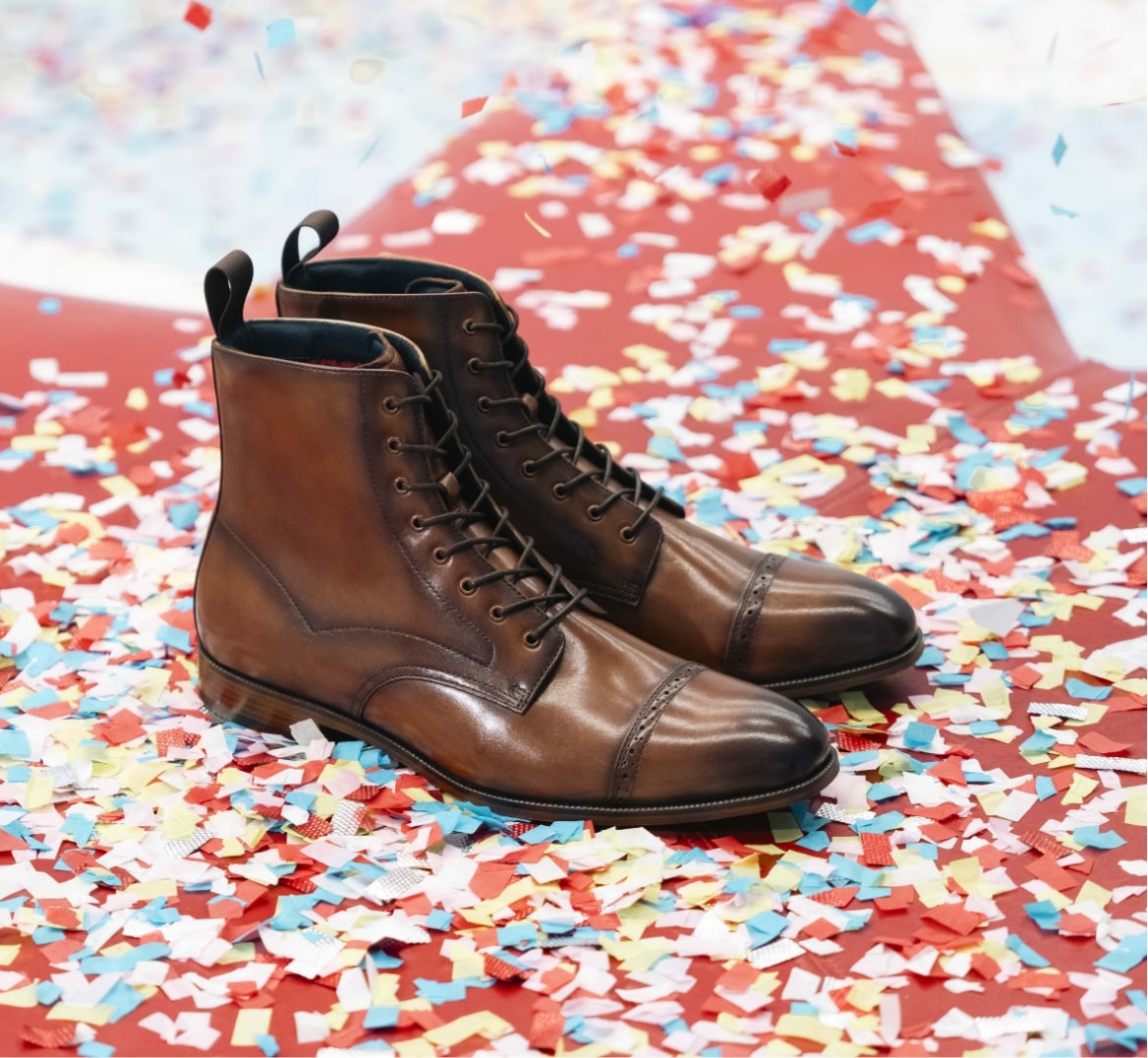 Shop the Stacy Adams classics featuring the Henry boot surrounded by confetti.