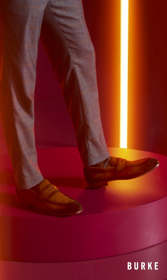 Men's Newest Shoes category. Image features the Burke penny loafer in cognac. 