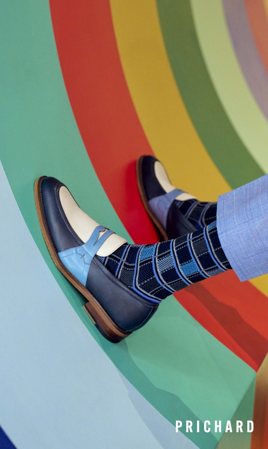 Men's Dress Shoes category. Image features the Prichard in navy multi on a rainbow background.